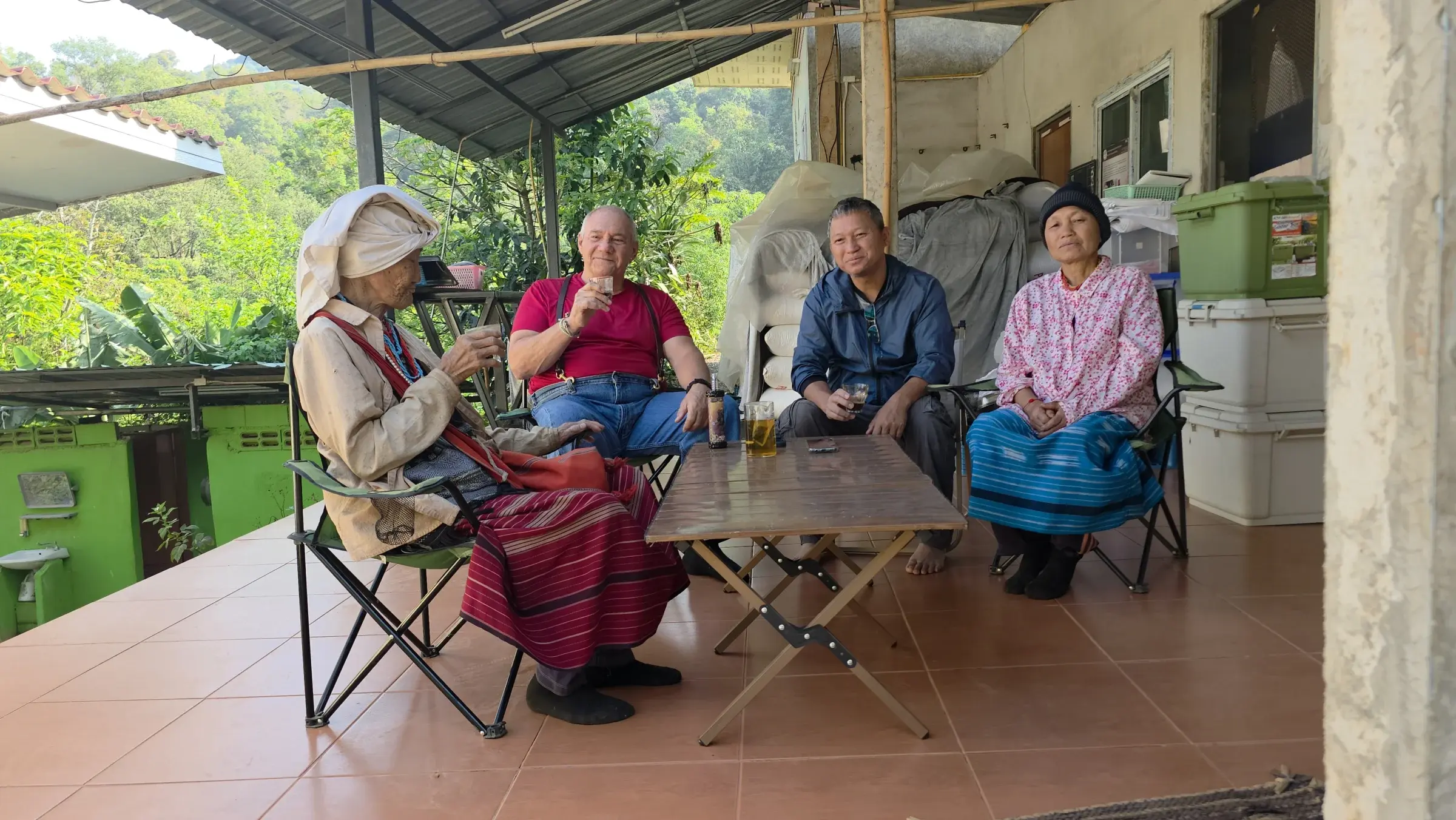 Jack with Manap, his mother and grandmother sharing coffee on the mountain farm