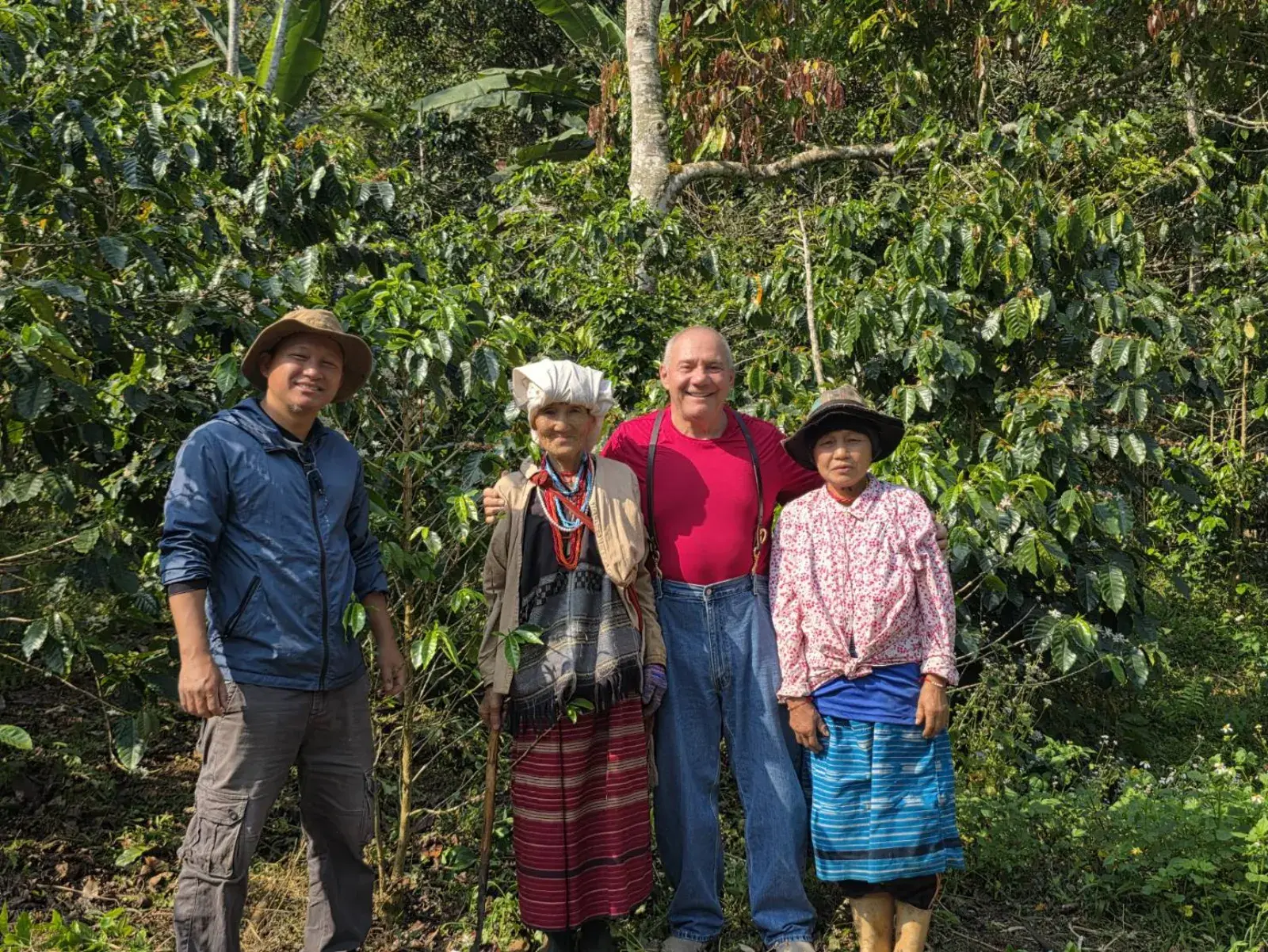 Jack with Manop and his family in front of the coffee trees